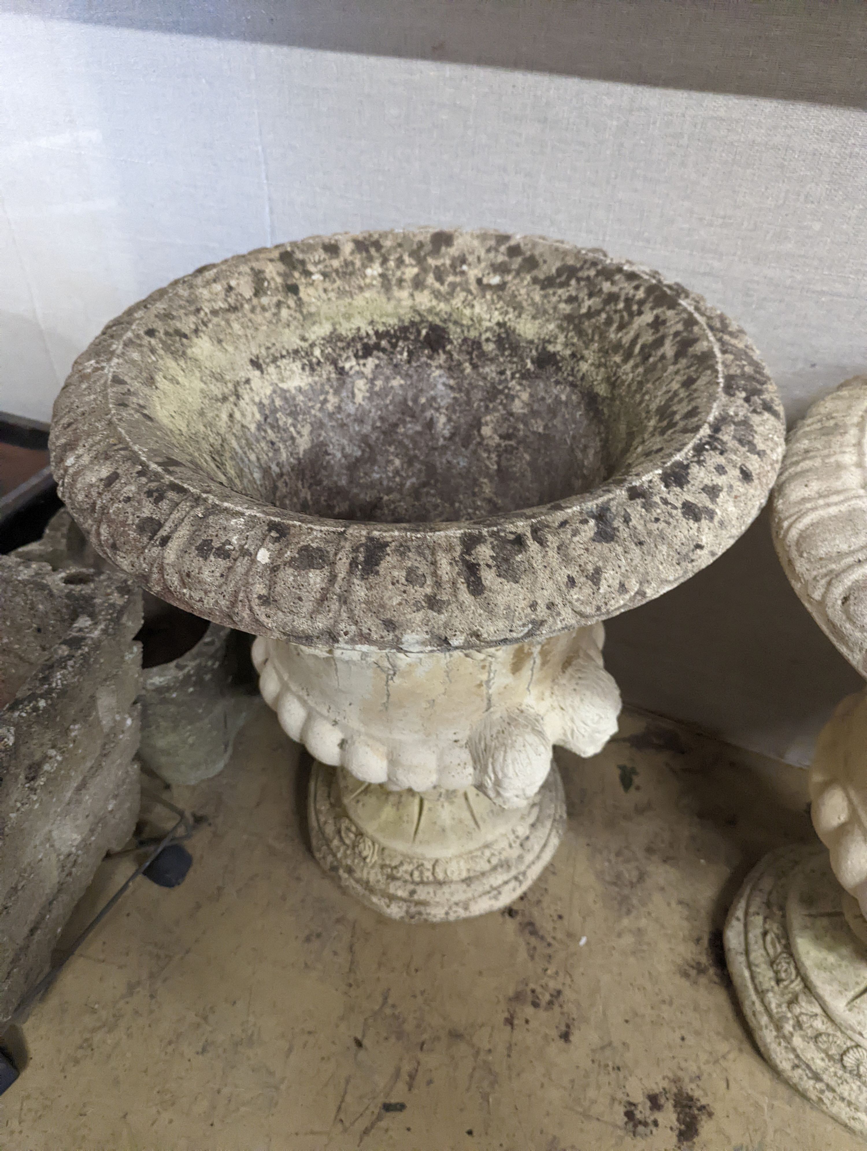 A pair of reconstituted stone campana garden urns, diameter 54cm, height 64cm